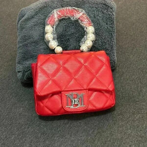 Small, red, Badley Mischka with pear handle also with shoulder strap.